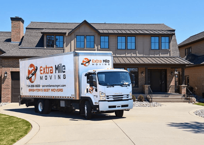 Extra Mile Moving truck in front of a customer's home